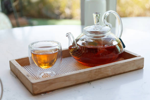 istock green tea in small cup and the kettle. 1261408852