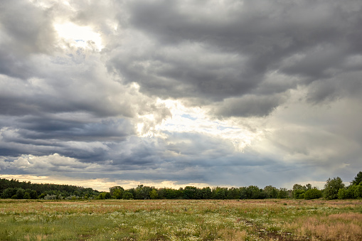 Afternoon thunderstorms and rainbow over Montana ranch muddy dirt road near Roundup and Billings Montana in northern USA, North America.