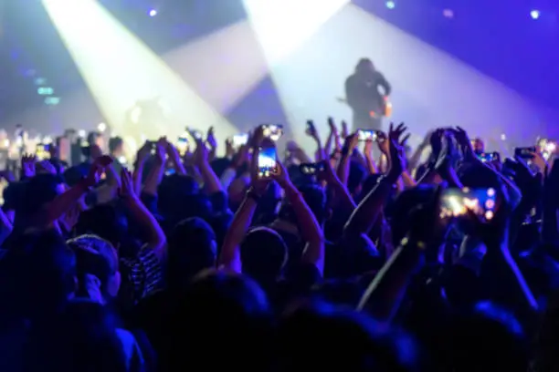 Photo of blur of People shooting video or photo in music brand showing on stage or Concert Live, party concept