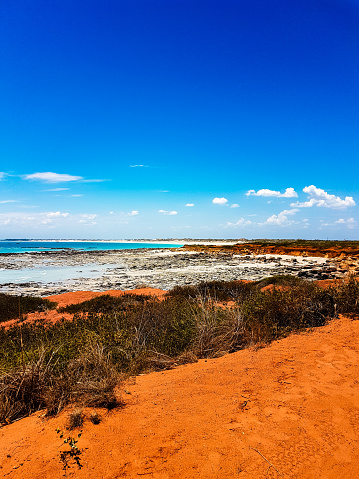 The bright red sand and turquoise waters along the coast of Broome in Western Australia