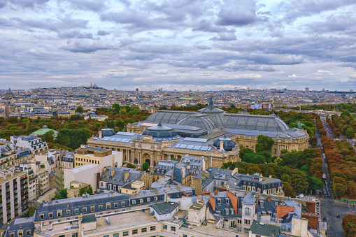 Aerial view of Paris with Grand and Petit Palais and Montmartre in background in the evening