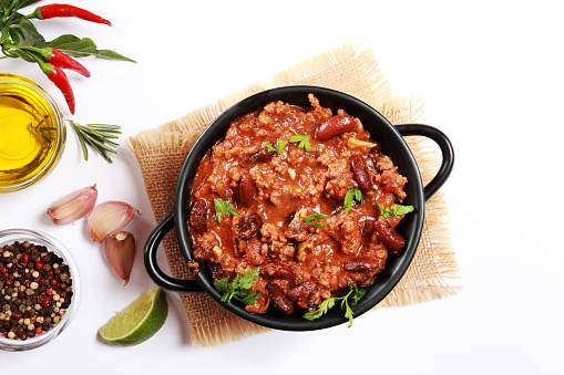 Chilli Con Carne with Minced Beef, Kidney Beans, topped with Coriander Leaves on white background