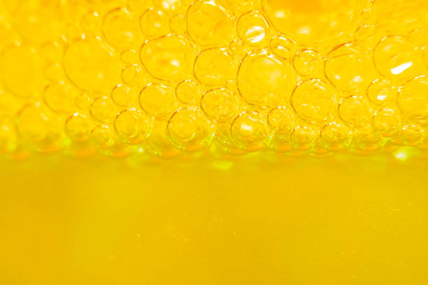 istock Blurred abstract light yellow background with bubbles. The concept is summer, soft drinks, freshness. For the backing of a site or mobile application. 1261454758