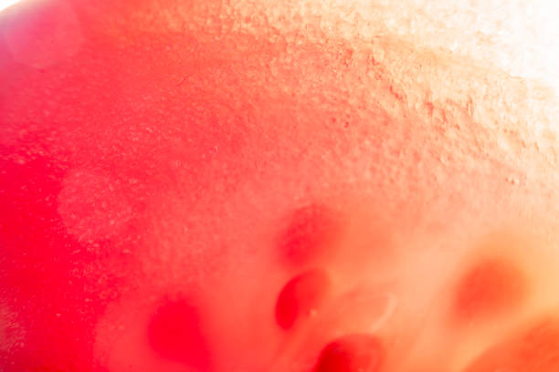 istock Background with sliced tomato under strong magnification in soft focus. A detailed image of the pulp of a ripe tomato. 1261454789