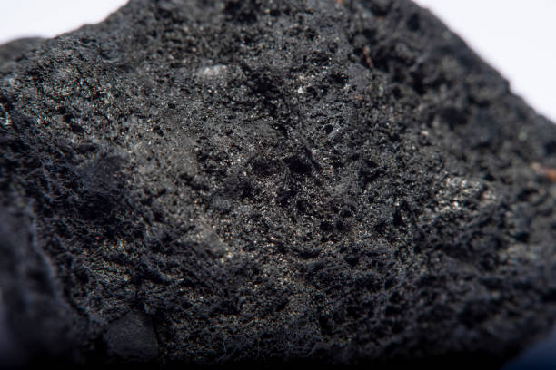 istock Blurred black background in soft focus with hard coal at high magnification. An image on the theme of geology and the extraction of minerals and natural fuels. 1261455348