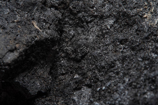 istock Blurred black background in soft focus with hard coal at high magnification. An image on the theme of geology and the extraction of minerals and natural fuels. 1261455359