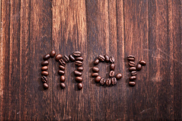 Roasted coffee beans in wooden bowl. View from above.
