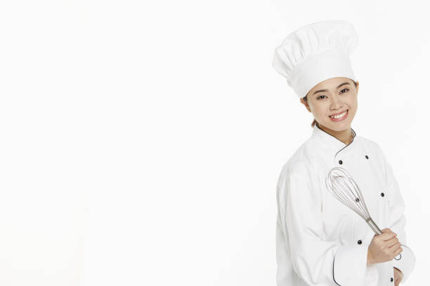 istock Female chef holding a wire whisk 1261470214