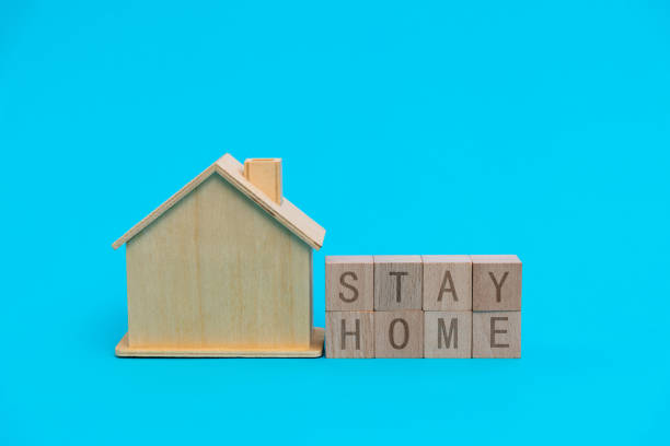 istock House model and stay home text on blue background 1261471955
