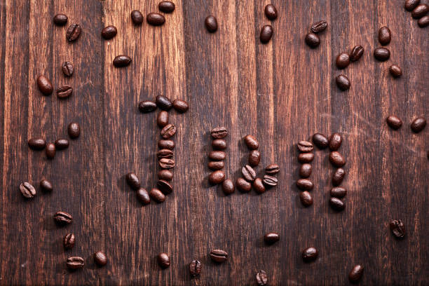 Decaf concept written on coffee beans and jute canvas fabric textile