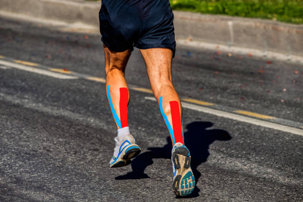 kinesio tapipng on calf muscle of runner - kinesio imagens e fotografias de stock