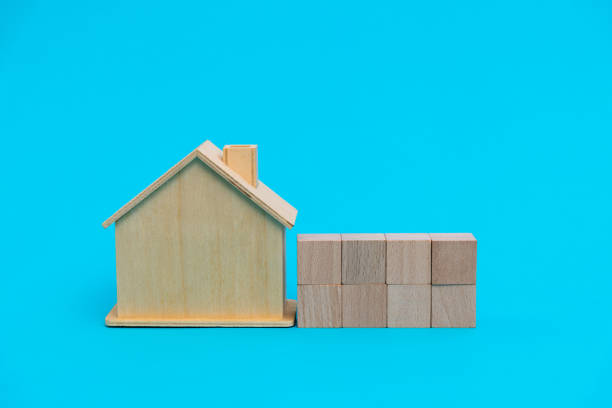 istock House model and toy block on blue background 1261472304
