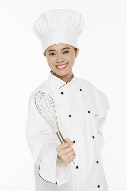 istock Female chef holding a wire whisk 1261477128