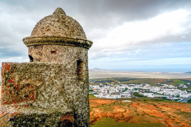 Teguise, Lanzarote, Canary Islands / Spain - March 8, 2011: Sentry box of Santa Barbara Castle with Teguise in the distance