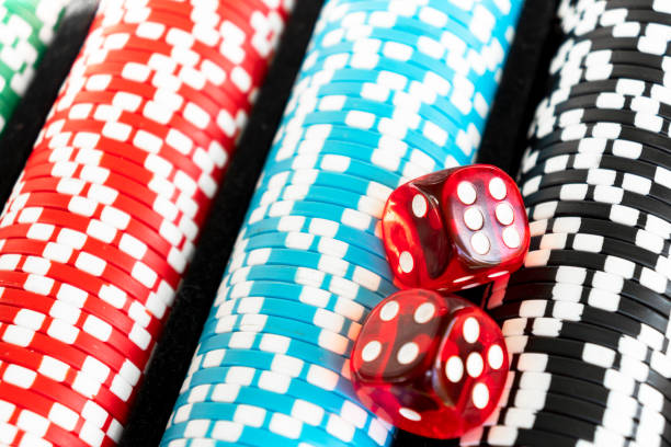 istock Stack of poker chips with dice rolls isolated background. Poker game concept. Playing a game with dice. Casino Concept for business risk chance good luck. Chips for poker game 1261502384