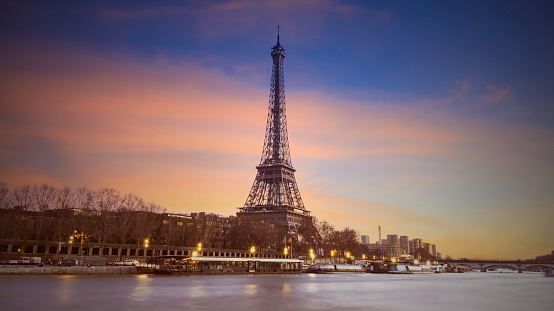 Eiffel tower in Paris, France with Scenic panorama of the river Seine under the twilight skyline with port of Seine river