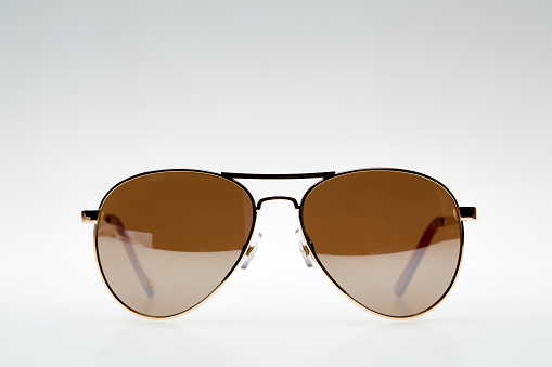 Close-up view of dark sunglasses on a light background