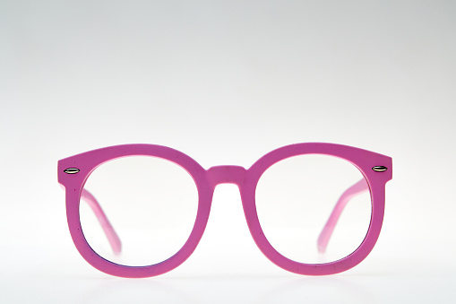 Pink eyeglasses isolated on white background