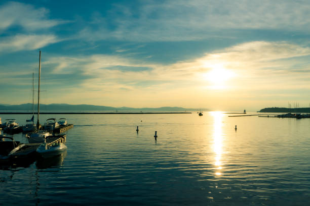 Boats in harbor of lake champlain at sunset stock photo