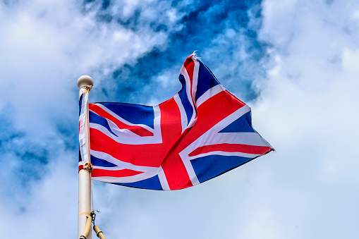 Central London,England,United Kingdom-August 21 2019:On a summer day,Union Jack flags fly over the sunny,quintessential streets of the vibrant English capital.