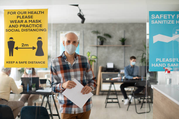 istock Economist with protective face mask in bank office 1261542010