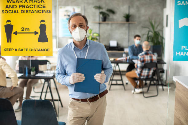 istock Businessman with protective face mask in bank office 1261542025