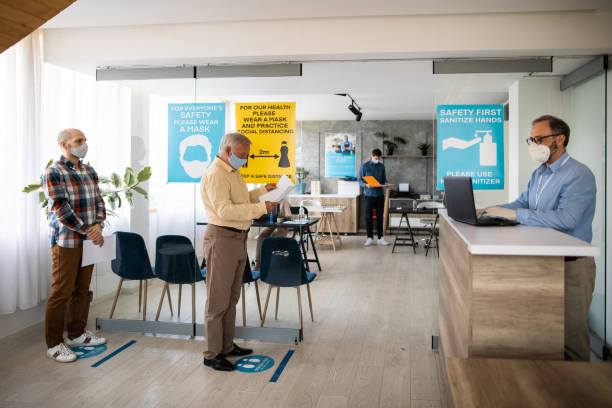 istock Clients keeps social distancing while waiting in front of bank counter 1261543092