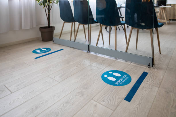 istock Social distancing information sign on floor at bank 1261543112