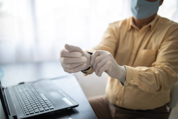 istock Businessman putting on protective gloves at bank office 1261543653
