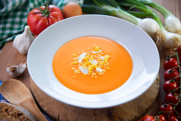 Cold tomato soup made with garlic, tomatoes, onion, bread and served with olive oil, iberico ham and boiled egg.