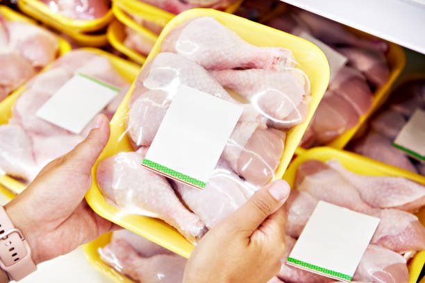 istock Hands with chicken meat in shop 1261557308