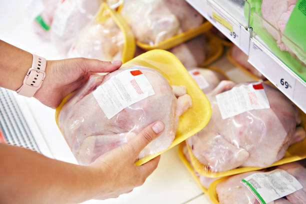 istock Hands with chicken meat in shop 1261558383