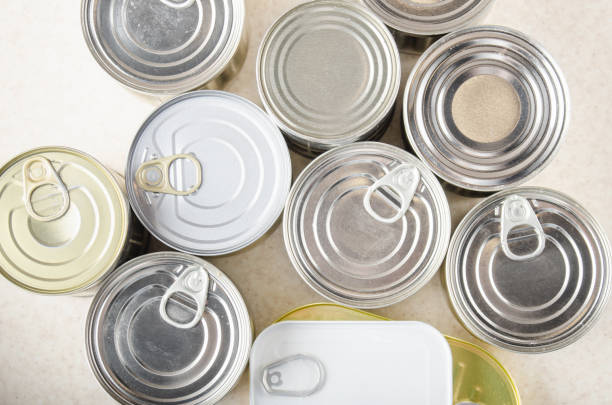 istock Flat lay view at various canned foods in tin cans on kitchen table, non-perishable, long shelf life food for survival in emergency conditions concept 1261561184