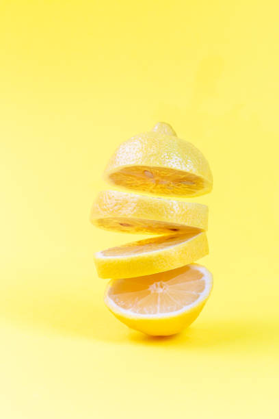 istock Levitation of lemon slices on yellow background, vertical 1261564696