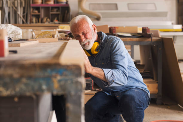 istock Senior woodworker checking if the wooden plank is even 1261568703