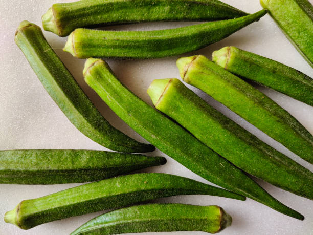 istock Many fresh lady's finger or okra isolated on white background. 1261579606
