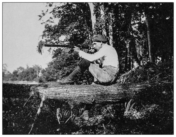 Antique black and white photo: Summer days, aiming, shooting Antique black and white photo: Summer days, aiming, shooting gun photos stock illustrations