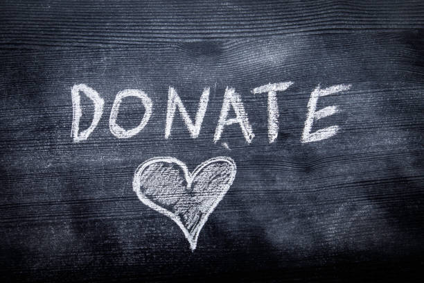 istock DONATE. Black painted wood and inscription with chalk 1261597826