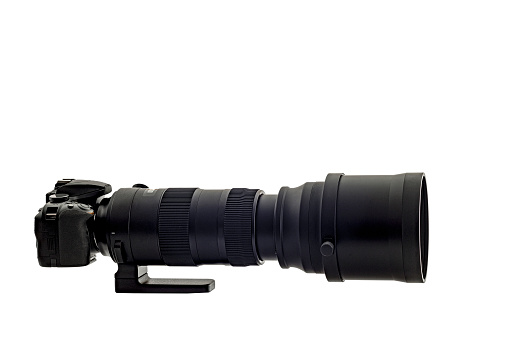 Horizontal shot of a super telephone zoom lens on a digital camera isolated on white. It is a side shot. Copy space.
