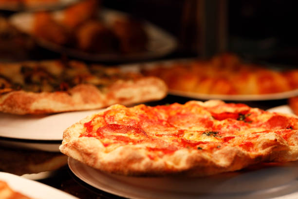 istock fresh-baked pizzas on pizzeria restaurant counter 1261614651