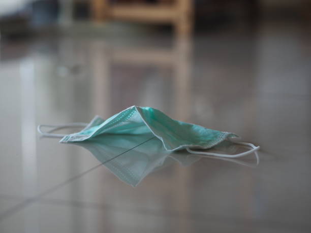 istock Used disposable face mask on the floor self prevention ill for protect dust and germs pm 2.5, coronavirus covid-19 1261615189