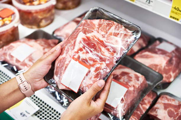istock Hands with pork neck in shop 1261619989