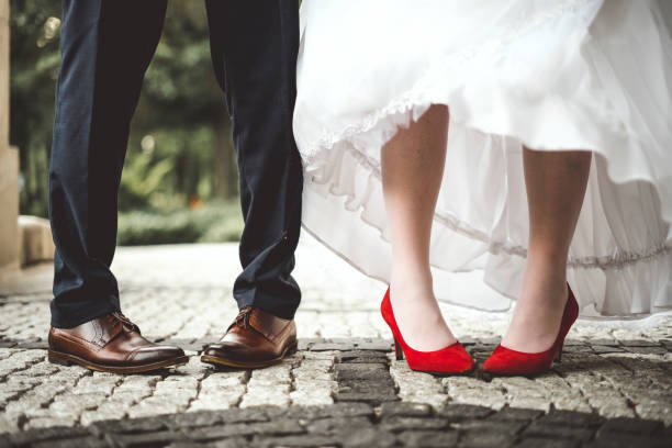 istock Bride's and groom's funny crossed legs 1261629229