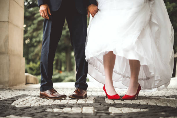 istock Bride's and groom's funny crossed legs 1261629231