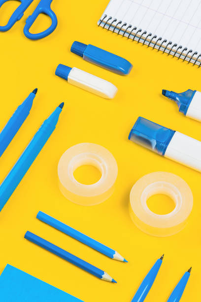 istock Assorted office and school white and blue stationery on yellow 1261636226