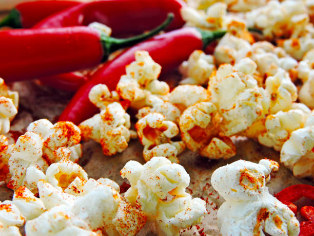 istock Spicy hot popcorn with chili pepper. 1261640745