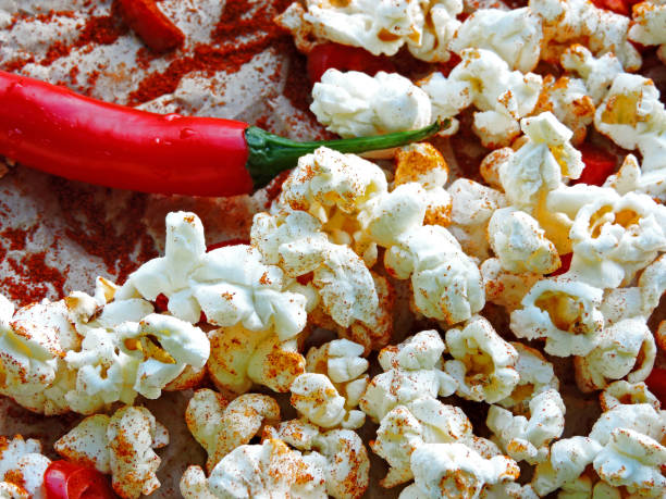 istock Spicy hot popcorn with chili pepper. 1261640755