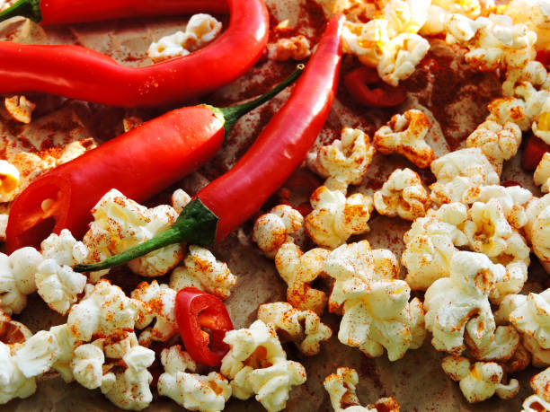 istock Spicy hot popcorn with chili pepper. 1261640757