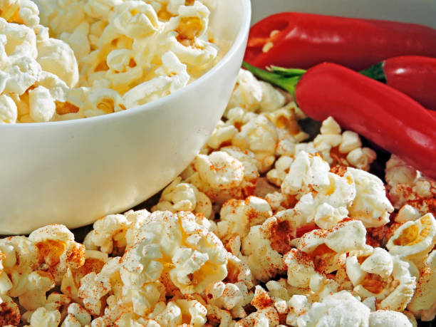 istock Spicy hot popcorn with chili pepper. 1261649838
