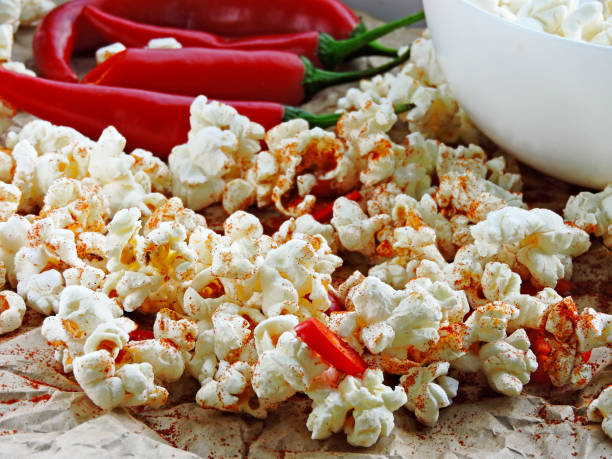 istock Spicy hot popcorn with chili pepper. 1261649858